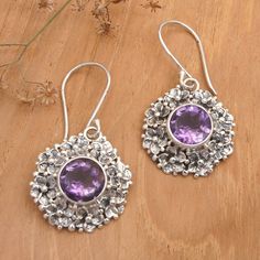 Indulge in the luxurious allure of these sterling silver dangle earrings that boast exquisite Frangipani accents. Nestled within the intricate motifs lies a sumptuous amethyst gemstone, creating a breathtaking contrast that exudes timeless elegance. Designed by Bali's Buana, the earrings' fusion of oxidized and polished finishes imparts a captivating depth that makes them a true work of art. Elegant Purple Sterling Silver Flower Earrings, Elegant Silver Flower Earrings With Gemstone, Amethyst Color, Silver Dangle Earrings, Sterling Silver Dangle Earrings, Amethyst Earrings, Silver Earrings Dangle, Jewelry Packaging, Amethyst Gemstone