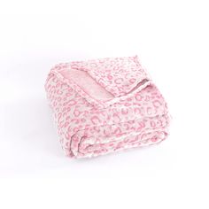 the pink leopard print blanket is folded on top of it's white surface,