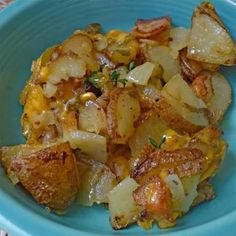 a blue bowl filled with potatoes and meat