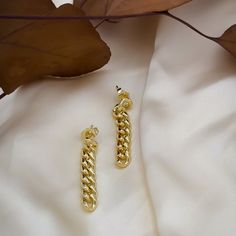 If you’re looking for a bold, statement-making earring that won’t break the bank, then this is it. With its 18k gold-filled Cuban link chain and drop style stud design, our Tatum Chain Link Earring is the perfect way to add some sass and glamor to your outfit. Wear them with jeans and t-shirt or dress them up with a cocktail dress and heels-no matter how you wear them, they’ll be sure to turn heads! Box Chain Link Earrings As Gift, Chunky Chain Link Earrings, Gold-tone Chain Detail Gold Plated Earrings, Gold-tone Chain Earrings Gold Plated, Gold Chain Earrings For Gift, Gold Cable Chain Earrings For Gift, Gold Chain Link Earrings Tarnish Resistant, Gold Chain Link Earrings For Gift, Yellow Gold Chain Link Earrings For Gift