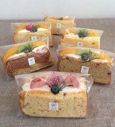 several slices of cake in plastic bags with fruit on top