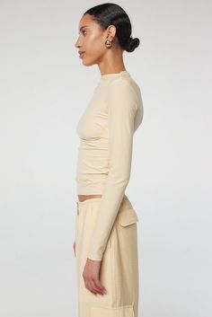 Selma: High neck, slim long sleeves in a cotton-modal blend. Effortless drape with hand-pleated details. 45% Cotton 45% Modal 10% Spandex. Versatile Long Sleeve Elastane Top, Stretch Modal Long Sleeve Tops, Versatile Soft Stretch Long Sleeve Top, Versatile Long Sleeve Top With Soft Stretch, Fitted Long Sleeve Modal Top, Fitted Modal Long Sleeve Tops, Long Sleeve Tops With Thumbholes, Long Sleeve Tops For Layering With Minimal Stretch, Long Sleeve Tops With Minimal Stretch For Layering