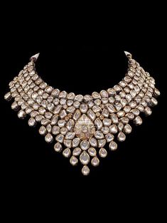 "Mendhika Jadau Polki Set A gold tone chunky Polki Jadau Necklace Set with big Kundan stones. An array of mini polki pieces encircle a jadau kundan pear shape motif with beautiful matching jhumkis/earrings. Can be worn with a statement long necklace for a bridal jpiece. Approximate earrings length is 3.5\". * Check out Manpreet Toor wearing this for a shoot to see the entire look! Tikka and different set of earrings can be added for additional cost. Gold-plated on high-quality brass as base meta Kundan Sets Indian Jewelry, Shaadi Jewelry, Polki Tops, Girly Jewellery, Rajwadi Jewellery, Manpreet Toor, Kundan Bridal Jewellery, Jadau Necklace Set, Kundan Polki Necklace