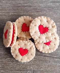 four small cookies with red hearts on them