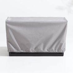 an outdoor grill cover on top of a table