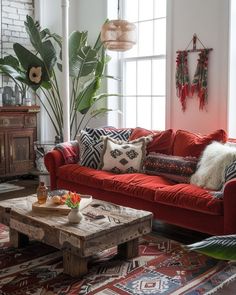 a living room with red couches and rugs