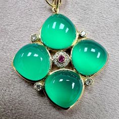 Created in 18 karat yellow gold  Green Chalcedony 22 carats approx.  Ruby 0.05 carat approx.  Diamonds 0.20 carat approx.  Chain sold separately  Limited edition    Crafted from 18k yellow gold and adorned with 22 carats of Green Chalcedony, a 0.05 carat Ruby, and 0.20 carats of Diamonds, this handcrafted pendant is a limited edition piece. Chain sold separately.      About the Designers ~ Dharmesh & Namrata    Drawing inspiration from little things, Dharmesh & Namrata Kothari have created an ex Red Pendants, Green Chalcedony, Art Deco Pendant, Blue Pendant, Contemporary Pendant, Modern Pendant, Silver Pendants, Drawing Inspiration, Gold Pendant