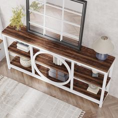 a white and wood entertainment center with a mirror on it's sideboard next to a rug