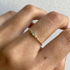 a woman's hand with a diamond ring on it