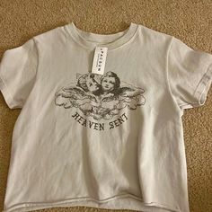 White Crop Top With “Heaven Sent” Words And Design! Aesthetic Graphic Print Tops For Summer, Aesthetic Summer Tops With Letter Print, Aesthetic Letter Print Summer Tops, White Aesthetic Summer Tops, Aesthetic Graphic Print Tops For Spring, Pacsun Aesthetic, Aesthetic Crop Top, Pacsun Sweaters, Ruffled Crop Top