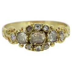 Here we have a charming diamond ring dating back to the Georgian period. The head of this dainty antique piece has been crafted from a rich 18ct yellow gold with ornately curvaceous shoulders flanking a delightful centralised cluster consisting of old and rose cut diamonds of differing shapes and sizes. We believe a more more practical and robust band has been added a later date here to ensure the piece's longevity. Condition: Used (Good) Weight: 2.3 grams Band With: 3mm Ring Size: O (55) Diamond Weight: 0.74ct Tested As: 18ct Gold Box: The Vintage Jeweller Ring Box Comments: Diamond estimations are particularly conservative due to the closed back setting Antique 14k Gold Cluster Ring With Rose Cut Diamonds, Victorian Gold Cluster Ring With Rose Cut Diamonds, Antique Multi-stone Cluster Ring, Georgian Cluster Ring, Luxury Antique Multi-stone Cluster Ring, 3mm Ring, Gold Box, Sparkly Things, More More