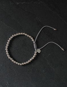 Crafted with tarnish-resistant sterling silver beads, this versatile piece is elegant yet perfect for everyday wear. Its adjustable design ensures a perfect fit for any wrist, making it a must-have addition to any collection. Macramé style bracelet Sterling Silver Beads Thread Color: Silver Adjustable from 3-5 inches in diameter 100% handmade, therefore slight variations may occur Everyday Silver Jubilee Braided Bracelet, Everyday Adjustable Round Bead Bracelet, Elegant Adjustable Beaded Braided Bracelets, Spiritual Adjustable Bracelets For Everyday, Adjustable Silver Beads Spiritual Rosary Bracelet, Adjustable Everyday Beaded Bracelets, Adjustable Spiritual Rosary Bracelet With Silver Beads, Handmade Sterling Silver Beaded Bracelets, Sterling Silver Round Beads Jewelry For Everyday