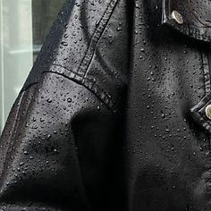 a black leather jacket with rain drops on it