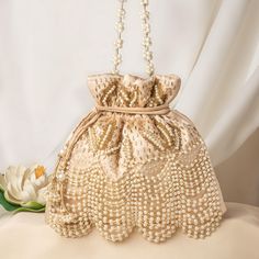 Glamorous Pearl Glass Bead Hand Embroider Satin Bridal Potli | Ethnic Drawstring Wedding Handbag for Women | Handcrafted Fashionable Purse Package Contents: 1 Size: 10" x 8" Designed with the heart, this beautiful Potli or batawa bag are eye catchy and made of premium material. Key Features: Embroidery art work. (bead work). This potli is good match with both Indian and western outfits and are superb for wedding and festive parties. This would be best complement to your designer saree, lenhga or any other kind of dress. This is the combination of traditional and modern embroidery work. This is enough to keep your accessories and all needed essentials and it can be a best gift for any woman. Wedding Handbag, Bridal Handbags, Bridal Purse, Ethnic Bag, Potli Bags, Bridal Dress Design, Handbag For Women, Modern Embroidery, Purse Styles