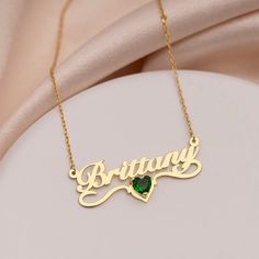 Unveil Your Unique Elegance with Our Shimmering Name Necklace with Birthstone Celebrate the special moments in life with a piece that embodies elegance and thoughtfulness. Our Shimmering Name Necklace with Birthstone is a true testament to fine craftsmanship, meticulously fashioned from premium sterling silver or 18k gold plating. This minimalist masterpiece is the ideal gift for birthdays, anniversaries, or any occasion that calls for something extraordinary. What makes this necklace truly special? It's the personal touch that transforms it into a cherished keepsake. Customize it with a name, a significant date, or a meaningful word, making it a unique symbol of your love and thoughtfulness. Our Shimmering Name Necklace with Birthstone is more than just jewelry – it's a heartfelt gift tha Elegant Gold Plated Round Birthstone Necklace, Luxury Gold Birthstone Necklace Gift, Elegant Cubic Zirconia Name Necklace, Elegant Engraved Necklace For May Birthstone, Personalized Rose Gold Elegant Necklace, Elegant Personalized Rose Gold Necklace, Rose Gold Name Necklaces For Wedding, Engraved Cubic Zirconia Jewelry For Gift, Anniversary Cubic Zirconia Nameplate Jewelry