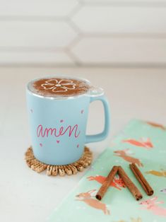 a blue mug with cinnamon sticks next to it