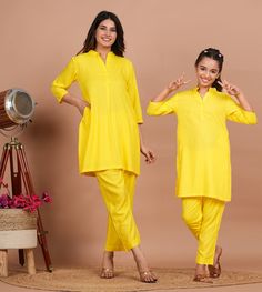 Mother's Kurta Set:-Readymade Rayon Straight Kurta in Yellow This attire is Crafted in Chinese Collar and Quarter Sleeve Available with a Rayon Palazzo in Yellow along with both side Pockets Do note: Accessories shown in the image are for presentation purposes only and length may vary upto 2 inches.(Slight variation in actual color vs. image is possible). Daughter's Kurta Set:- Readymade Rayon Short Kurti in Yellow This Chinese Collar and Quarter Sleeves Co-Ord Set attire with Lining is Enhanced Vs Image, Angrakha Style, Dabu Print, Short Kurti, Chinese Collar, Utsav Fashion, Nehru Jackets, Rayon Pants, Straight Kurta