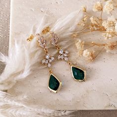 These exquisite emerald green drop earrings are the perfect accessories for your boho woodland wedding and the special touch for your whimsy outfit! These dangling drop earrings are made of 14k gold plated brass elements, cubic zirconia art deco rhinestones and splendid emerald green teardrops.  DETAILS: - materials: 14k gold plated brass, Cubic Zirconia rhinestones, glass crystals - total length: 4.5 cm - weight: 2.1 grams - lightweight, comfortable and easy to wear - AAA high quality materials EXCLUSIVE DESIGN BY L'ACCHIAPPASOGNI JEWELRY since 2024 © L'Acchiappasogni Jewelry These earrings come packaged in a kraft paper gift box with cute, handmade details. SHIPPING All orders will be shipped out through DHL Express, FedEx or UPS Express. Please double check the address is correct before Emerald Green Earrings Wedding, Elegant Green Crystal Earrings For Pierced Ears, Green Pierced Chandelier Earrings For Party, Green Chandelier Pierced Earrings For Party, Green Crystal Earrings For Pierced Ears, May Birthstone Crystal Drop Earrings, Elegant Green Crystal Dangle Earrings, Elegant Green Teardrop Earring (single), Emerald Drop Crystal Earrings