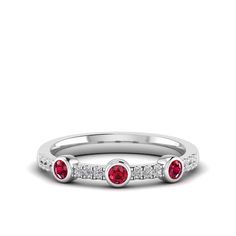 This exquisite diamond and ruby ring is a stunning piece of jewelry that exudes elegance and sophistication. The brilliant diamonds and vibrant rubies are set in a beautifully crafted, creating a luxurious and eye-catching design that is sure to make a statement. Metal: 14K Gold Setting Type: Prong Rhodium Finish: Yes, on White Gold Gemstone Details: Gemstone: Ruby Shape: Round Average Dimensions: 2.50 MM Quantity: 03 Average Cut: Very Good Average Color: Medium to Dark Red Average Clarity: Eye Dazzling Red Ruby Ring With Diamond Accents, Red Ruby Ring With Diamond Accents, Dazzling Red Diamond Ring With Diamond Accents, Dazzling Red Diamond Ring With Accents, Red Diamond Ring With Accents, Elegant Three Stone Red Diamond Ring, Elegant Three-stone Red Diamond Ring, Diamond White Ruby Ring With Diamond Accents, Elegant Red Three Stone Diamond Ring