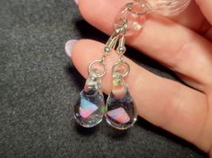 "Make a splash with these Mermaid's Tears earrings!  These gorgeous hand-blown teardrop earrings are made with only the highest quality borosilicate glass and features a mesmerizing Gilson opal polished nugget that shimmers with blue, green, yellow, and even a hint of red within the opal encased in glass. These earrings come mounted on sturdy sterling silver fish hooks, perfect for those with sensitive ears. And with a heavy gauge sterling that won't bend out of shape, you can wear these earring Nickel-free Glass Drop Jewelry, Nickel-free Teardrop Glass Jewelry, Nickel-free Glass Teardrop Jewelry, Hypoallergenic Teardrop Glass Jewelry, Glass Teardrop Jewelry With Matching Earrings, Glass Drop Earrings With Matching Set, Hypoallergenic Glass Teardrop Jewelry, Glass Drop Earrings As Gift, Nickel-free Teardrop Glass Earrings