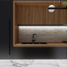 a kitchen with marble counter tops and wooden cabinets, along with a black faucet