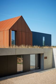 a building with grass growing on the roof