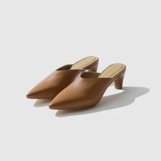 Classic Slip-on Mules For Evening, Chic Slip-on Block Heels With Padded Heel, Chic Slip-on Block Heel Heels, Chic Slip-on Block Heels For Formal Occasions, Classic Mules With Sculpted Low Heel, Classic Closed Toe Mules For Evening, Classic Low Heel Mules With Padded Heel, Classic Evening Slip-on Mules, Classic Low Heel Mules For Office