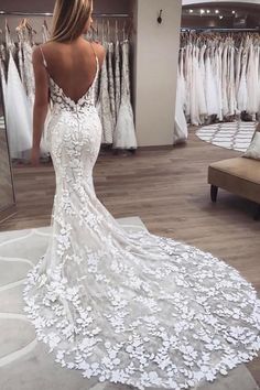 a woman is looking at her wedding dress in the mirror