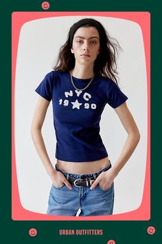 '90s baby tee vibes with this soft and stretchy cropped top complete with NYC applique at the chest. The perfect basic t-shirt is only at Urban Outfitters. Features NYC 1990 applique baby tee Soft and stretchy baby tee Raw-edge NYC applique at the chest Bodycon fit Crew neckline Short sleeve Cropped length UO exclusive Content + Care 100% Cotton Machine wash Imported Size + Fit Model in Grey is 5’10.5" and wearing size Medium Measurements taken from size Medium Chest: 28" Length: 21" | NYC 1990 90s Style Stretch Crew Neck T-shirt, Fitted 90s Style Crop Top T-shirt, 90s Inspired Logo Print Summer T-shirt, Retro Cropped T-shirt With Text Print For Summer, Urban Outfitters Graphic Tee With Letter Print, 90s Inspired Blue T-shirt With Letter Print, 90s Style Stretch T-shirt With Short Sleeves, 90s Inspired Text Print T-shirt For Spring, 90s Style Stretch Crew Neck Top