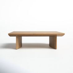 a wooden bench sitting on top of a white floor