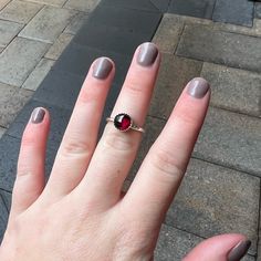 Garnet symbolizes love and is the gemstone to give for the 2nd anniversary. It is also the birthstone for January. This simple sterling silver stacking ring is a great gift, or an addition to a collection of stacking rings. Here are the details: This ring is made with a 4mm or 5-6mm bezel set garnet cabochon set on a sturdy sterling silver band handmade in your size. It can be worn with other stackable rings, or by itself.Please select your ring size. Sizes are US based. Dainty Garnet Gemstone Rings, Silver Stackable Elegant Birthstone Ring, Silver Elegant Stackable Birthstone Ring, Elegant Silver Stackable Birthstone Ring, Elegant Stackable Sterling Silver Birthstone Ring, Elegant Garnet Stackable Rings, Classic Gemstone Birthstone Ring For Promise, Garnet Birthstone Ring With Accent Stones, Classic Promise Ring With Birthstone Gemstone