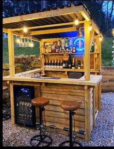 an outdoor bar with two stools under it