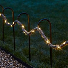 some lights that are on poles in the grass