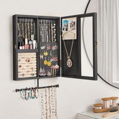 a mirror and jewelry rack in a room