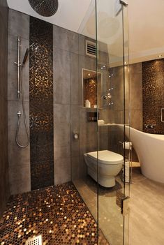 a bathroom with a tub, toilet and shower in it's center wall that has coins all over the floor