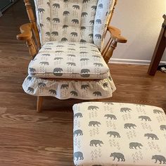 a rocking chair and footstool with bear print on the fabric, sitting in a living room