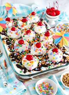 a cake with cherries and sprinkles in a pan on a table