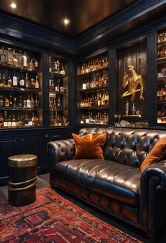 a leather couch sitting in front of a wooden shelf filled with bottles