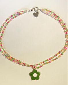 🎀 This super cute choker was made with glass seed beads on beading wire, and comes with a cute charm. 💙 This choker is perfect for adding an extra pop to any outfit! Trendy Choker Necklace With Spacer Beads, Seed Bead Charm Necklace, Trendy Beaded Chain Choker, Trendy Beaded Choker Chain, Trendy Green Beaded Choker, Trendy Handmade Beads Choker, Adjustable Multicolor Tiny Beads Choker, Spring Beaded Adjustable Choker, Adjustable Rainbow Beaded Choker Necklaces