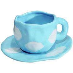 a blue cup and saucer with white clouds on it