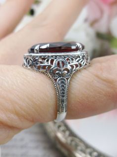 Red Garnet Ring Description Persian Design#230 MADE TO ORDER This is a brand new stunning Art Nouveau/Vintage designed sterling silver filigree 9ct oval red garnet CZ ring. The Flawless oval full cut high-quality garnet CZ is 18mm (just shy of 3/4th of an inch) by 13mm (1/2 inch) in dimension... This ring is 21mm NS on the finger. The inside of the band is marked 925 for sterling. Notice the beautiful filigree swirl like the craftsmanship of the silver setting. This lovely ring stands out and il Formal Oval Ring With Intricate Design, Classic Oval Ruby Ring, Victorian Red Oval Filigree Ring, Vintage Garnet Ruby Ring With Intricate Design, Vintage Ruby Ring With Intricate Design, Victorian Garnet Rings For Anniversary, Antique Style Oval Filigree Ring With Center Stone, Vintage Garnet Ring With Center Stone, Antique Oval Filigree Ring With Center Stone