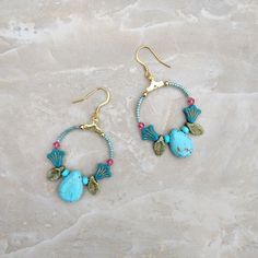 These beaded floral hoop earrings have a lovely mix of flowers, leaves, and large teardrop beads. With 18k gold-plated ear wires. Blue Teardrop Bohemian Flower Earrings, Bohemian Blue Teardrop Flower Earrings, Blue Bohemian Teardrop Flower Earrings, Bohemian Turquoise Flower Earrings Nickel Free, Bohemian Turquoise Hoop Earrings With Natural Stones, Bohemian Wire Wrapped Flower Earrings, Bohemian Turquoise Beaded Flower Earrings, White Howlite Jewelry, Celtic Knot Bracelet