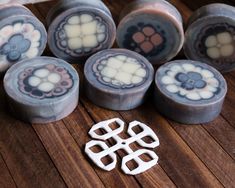 several decorative knobs on top of a wooden table next to a pair of scissors