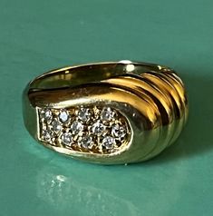 This dainty domed ring has an almost shell design to one side and twelve small sparkling diamonds on the other. The face of this ring is approximately 9mm wide and tapers off to a 2mm band in the back. This ring shows as a size 4 1/4, but perhaps because of the way it is made, it fits my size 5 finger. It is marked 14K and is in beautiful preloved condition. Please see all photos for details and condition. Thank you for looking! Gold Dome Ring, 5 Fingers, Shell Design, Dome Ring, Domed Ring, Sparkle Diamonds, Druzy Ring, Rings Statement, Statement Rings