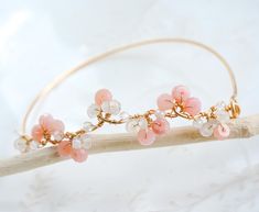 A delicate bangle inspired by nature itself. The bangle is used pink opal and moonstone gemstone beads, designed to represent small flowers blooming on a vine. It will be a jewelry that you will love to wear on any of your special occasions. - Material - 14K gold filled or Sterling silver - Gemstone - Pink opal,  Rainbow moonstone, Crystal quartz  - Band wire is made with 18gauge wire, Flower vine is made with 20gauge wire, please select a length. - Size - Flower vine measures 2.8" (7cm) - Come Delicate Pink Bracelets For Wedding, Delicate Pink Bracelet For Wedding, Delicate Pink Round Bracelets, Delicate Rose Quartz Jewelry For Wedding, Delicate Rose Quartz Wedding Jewelry, Handmade Delicate Rose Quartz Bracelet, Delicate Handmade Rose Quartz Bracelet, Bracelet For Wedding, Rose Quartz Wedding