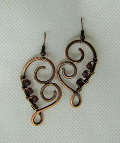 This listing is for one pair wire wrapped Heart Amethyst Crystal in Copper Earrings. Please read all listings carefully and if you have questions, address them to me and I will answer quickly. I thank you for shopping with Sparrow Song. New Pendant by Sparrow Song: Heart Shaped Copper and Crystal Earrings, measures 4.5 by 2.5 cms. Please inquire for your own tailor custom earrings with a choice of metal, crystal or stone. See what my customers are saying about my jewelry https://www.etsy.com/you Wrapping Crystals, Wire Wrapped Heart, Diy Wire Jewelry Rings, Wire Wrap Earrings, Wire Ideas, Wire Jewelry Earrings, Wire Jewelry Patterns, Wire Craft, Wire Wrap Jewelry Designs