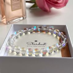 This glossy Mermaid glass bracelet is a treasure. Designed to attract those with enchanting style, these stones are made from exquisitely quality glass lined with brilliant colors to reflect light like sparkling rainbow moonstones. Also called Quartz Glowing Aura Moonstone is one of the top trending bracelets today. Also a great and stylish gift, for people who love modern design and want to add litlle sparkles in their lives. All jewelry comes in premium packaging, gift ready, plus a stylish po Trending Bracelets Bead, Mermaid Glass Bracelet, Round Crystal Bracelet As Gift, Spiritual Crystal Bracelets As Gift, Spiritual Crystal Beaded Bracelets, Spiritual Crystal Beaded Bracelet Gift, Clear Beaded Bracelets As A Gift, Clear Beaded Bracelets For Gift, Spiritual Crystal Beaded Bracelet For Gift