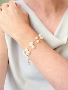 Make a classic and elegant statement with this multi-layered mixed pearl bracelet. Two handcrafted strands of differently shaped and sized pearls create a versatile accessory suitable for weddings, brunches, work, and more. The lobster clasp and extender ensure a secure and adjustable fit. Length: 7.5 inches plus 1.5-inch extender Materials: gold fill, cultured freshwater pearls GIFTING ~ Jewelry gift box included. ~ I am happy to ship directly to the recipient.  Enter their address during checkout. ~ If you would like a gift note included in the package, please leave the text of the note in the "Add a note to Marsh Creek Jewelry" message box at checkout. FREE SHIPPING ~ Orders ship within 2 business days. ~ Free shipping is First Class ~ Priority Mail and Express Shipping upgrades are ava Elegant Multi-strand Wedding Jewelry, Wedding Baroque Pearl Chain Bracelet, Elegant Multi-strand Pearl Drop Jewelry, Baroque Pearl Bracelets For Wedding, Baroque Pearl Wedding Bracelets, Pearl White Bracelets With Pearl Drop For Party, Pearl White Bracelet With Pearl Drop For Party, Silver Baroque Pearl Bracelets For Weddings, Wedding Bracelets In Pearl White Baroque Pearl