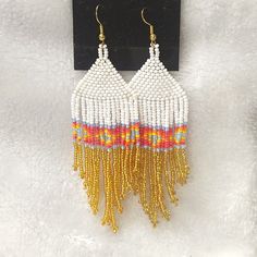 White, Gold, Light Blue, Pink, Mauve, Orange, And Yellow Beaded Fringed Earrings On Gold Tone Hooks. Diamond Design Band In The Fringes. 4 Inches Long. White Beaded Fringe Earrings For Festival, Elegant White Beaded Earrings With Colorful Beads, White Festival Jewelry, White Teardrop Beaded Earrings For Beach, White Beaded Earrings For Summer Beach, White Beaded Earrings For Beach Summer, White Beaded Earrings For Beach And Summer, White Teardrop Chandelier Earrings, White Chandelier Earrings For Festival