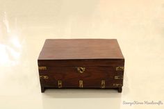 an old wooden box sitting on top of a table